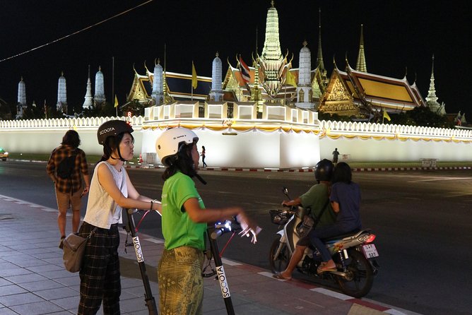 Bangkok at Night by Electric Scooter - The Grand Palace lit up from the road