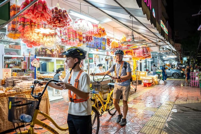 Bangkok by Night Cycling Tour with Street-food Meal - Chinatown under lanterns and shop signs