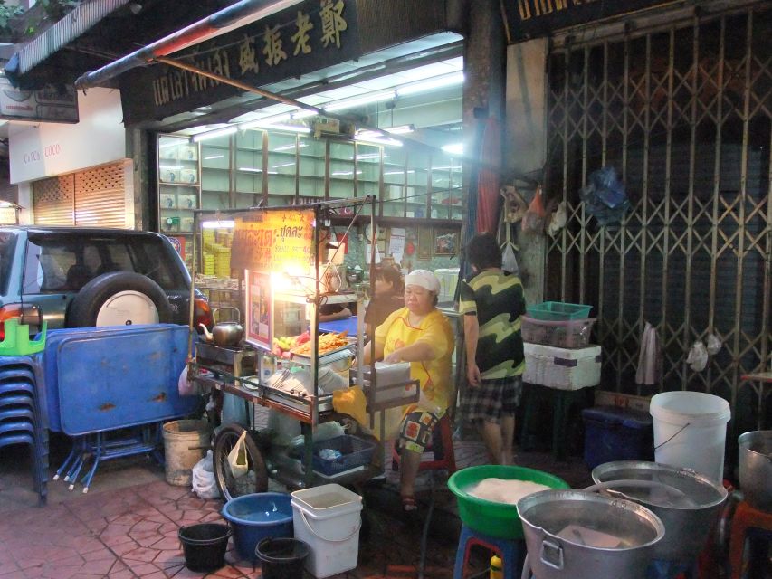 Bangkok by Night Cycling Tour with Street-food Meal - Eating a street-food dish with the group