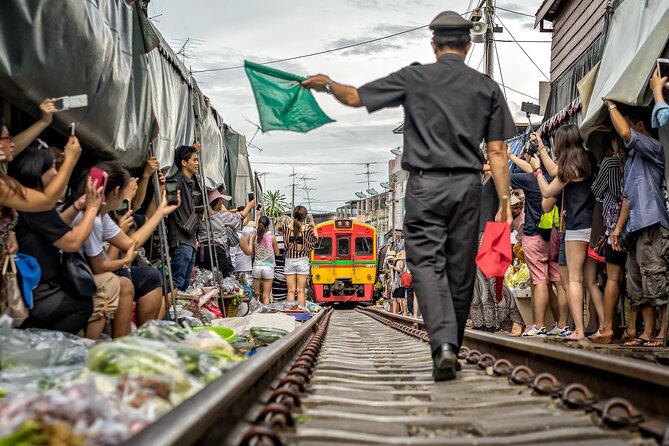 Damnoen Saduak Floating Market & Maeklong Railway From Bangkok - Pickup, van travel, and group coordination