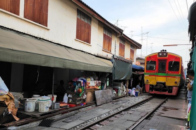 Private Maeklong Railway Market and Amphawa Day Tour from Bangkok - A train running through Mae Klong Market